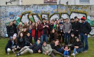 The StepIn exchange student group in front of a section of the Berlin Wall